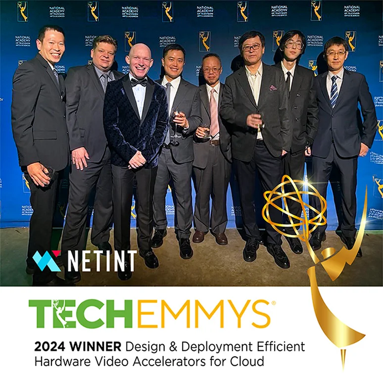 Group of well-dressed men posing together at an awards event, with Net.In.T logo and TechEmmys branding in the background/foreground.